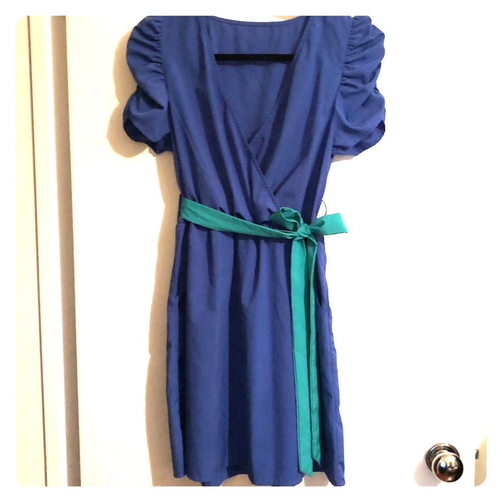 Short blue dress with teal bow and pockets